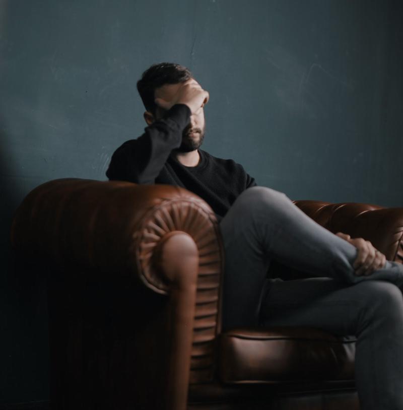 Man Grieving on Couch